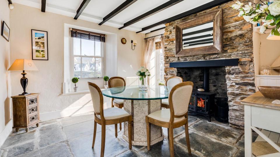 The inside has a dining room with a log burner as well as a stone fireplace