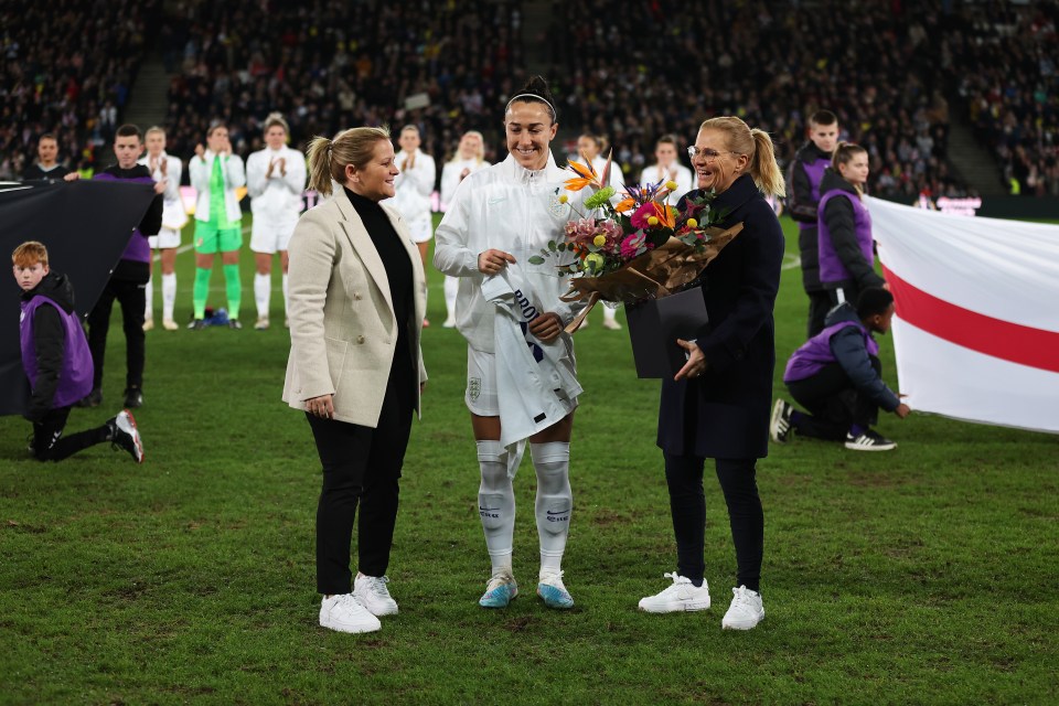 Lucy Bronze was presented with a bouquet by Wiegman and FA women's football technical director Kay Cossington after making 101 England appearances