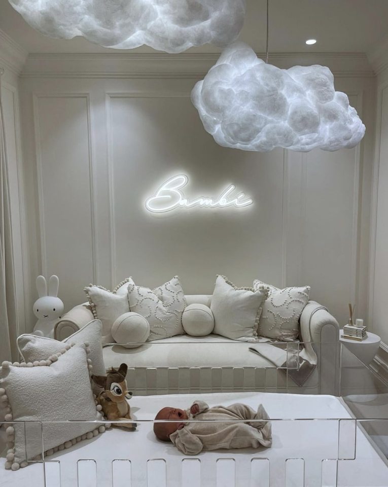 Baby Bambi's nursery with cloud lights and neon sign.