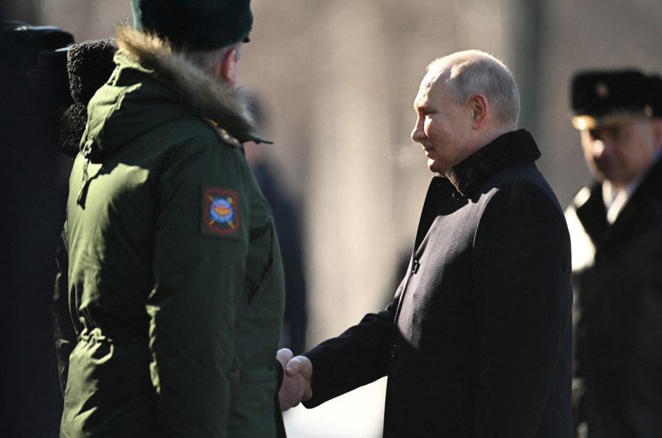 He shook hands with members of Russia’s armed forces