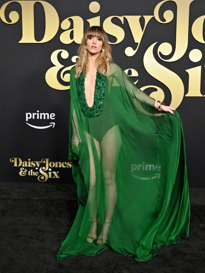 Suki Waterhouse showed off her figure in a sheer green cape