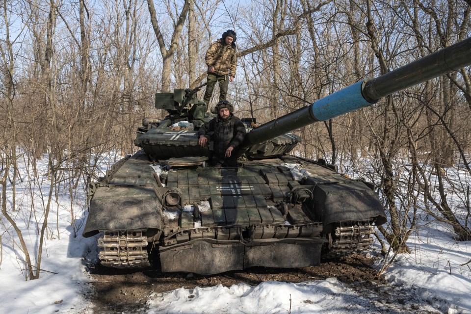 Ukrainian troops atop a T-64 tank in Bakhmut