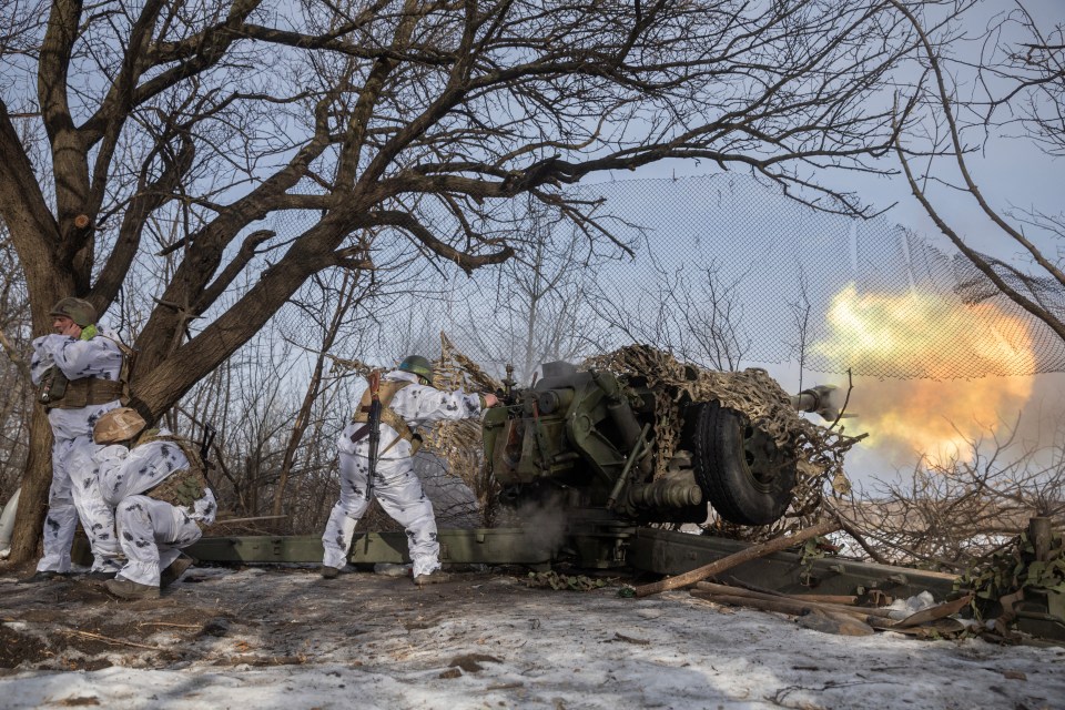 Ukrainian troops fire a Howitzer D-30 artillery weapon towards Russian troops near the frontline town of Bakhmut