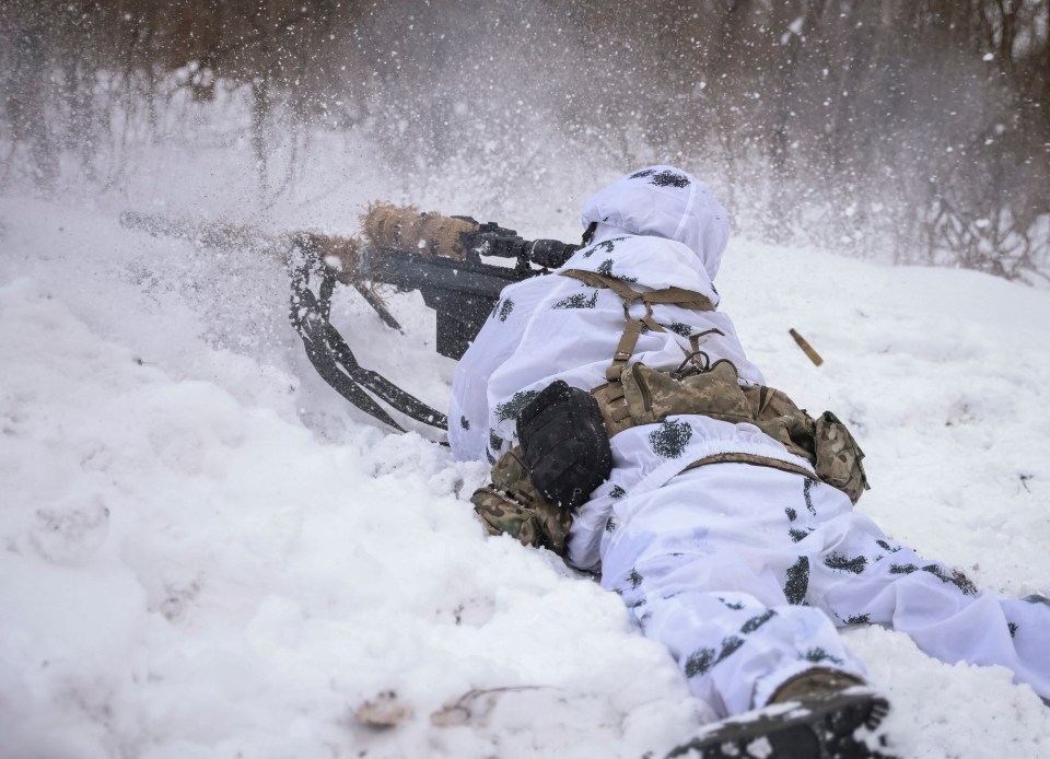 A Ukrainian sniper fires from his position in the city of Bakhmut