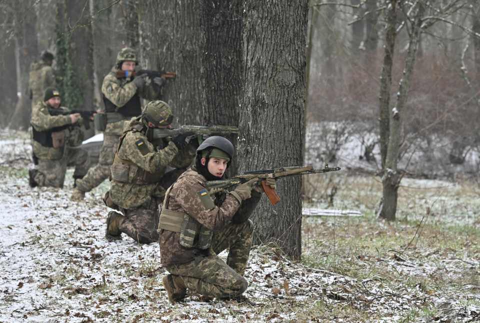 Ukrainian soldiers take firing positions while training in the south on February 1