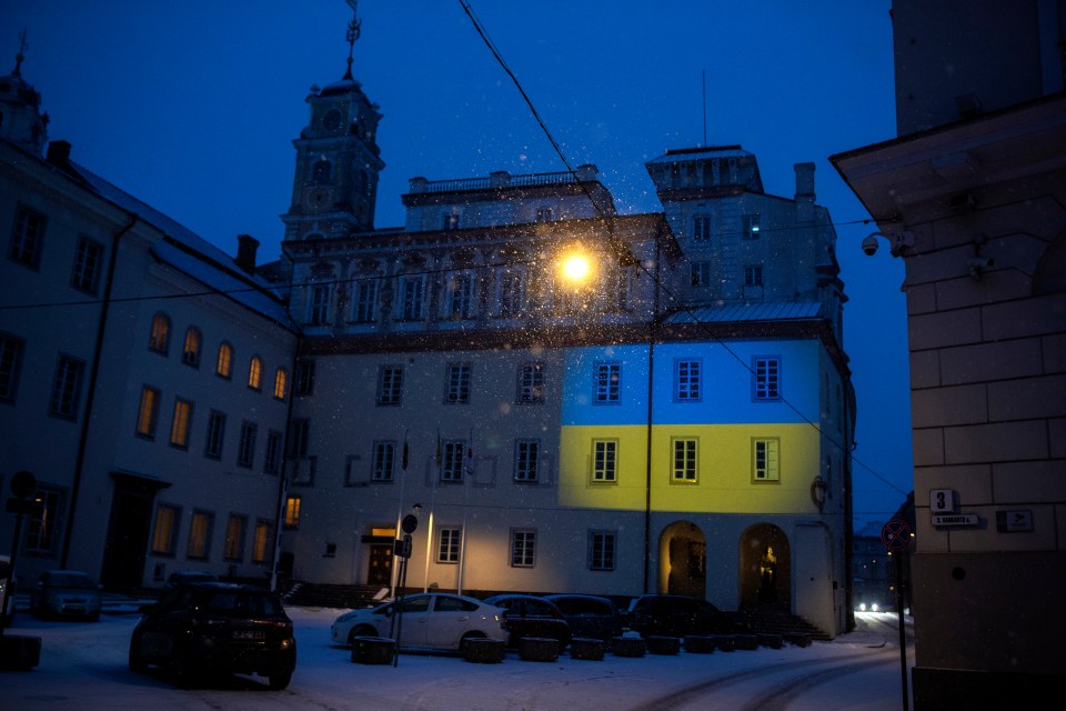 The Vilnius University building is illuminated with the colours of Ukraine in Vilnius, Lithuania