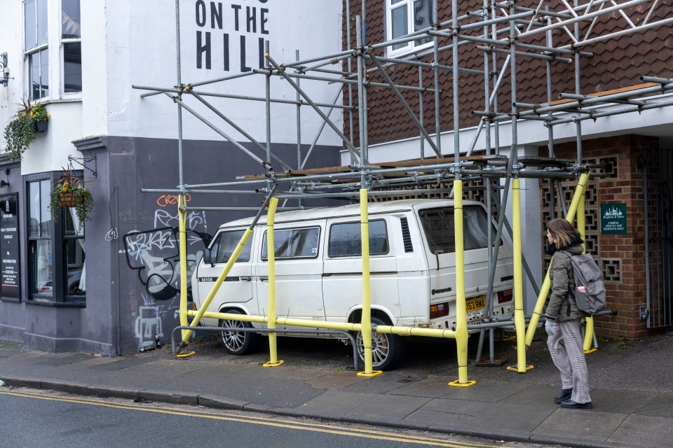 A bemused passer-by checks out the scene