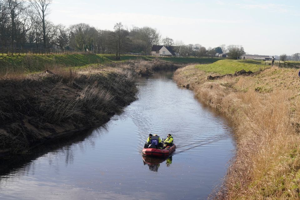 Workers from a private underwater search and recovery company on the river