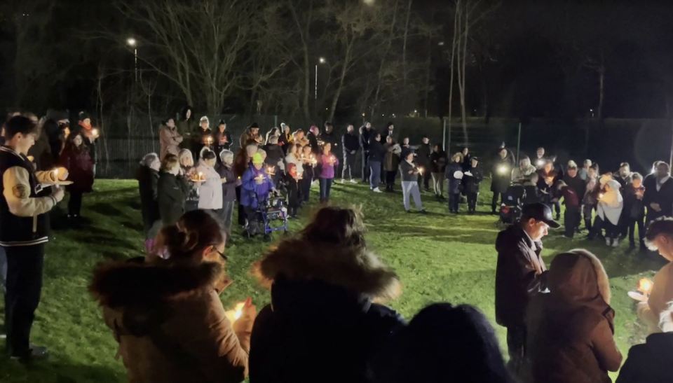 Dozens of mourners gathered for a candlelit vigil