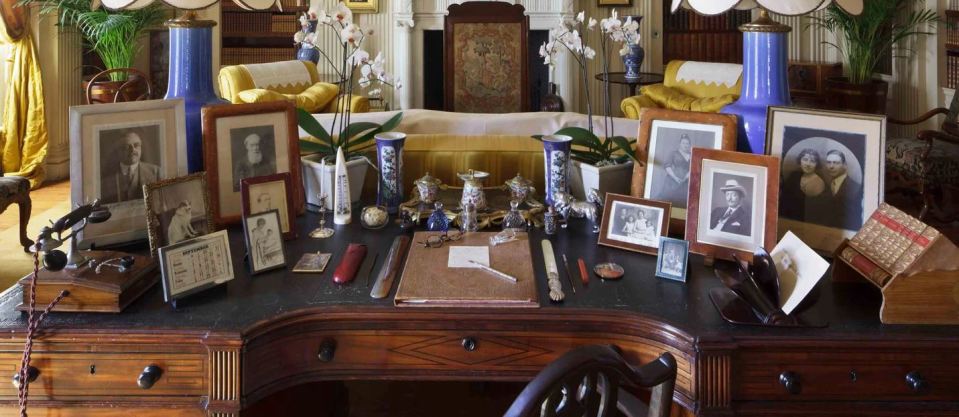 The huge writing table in the library has photographs of some of the property's famous guests