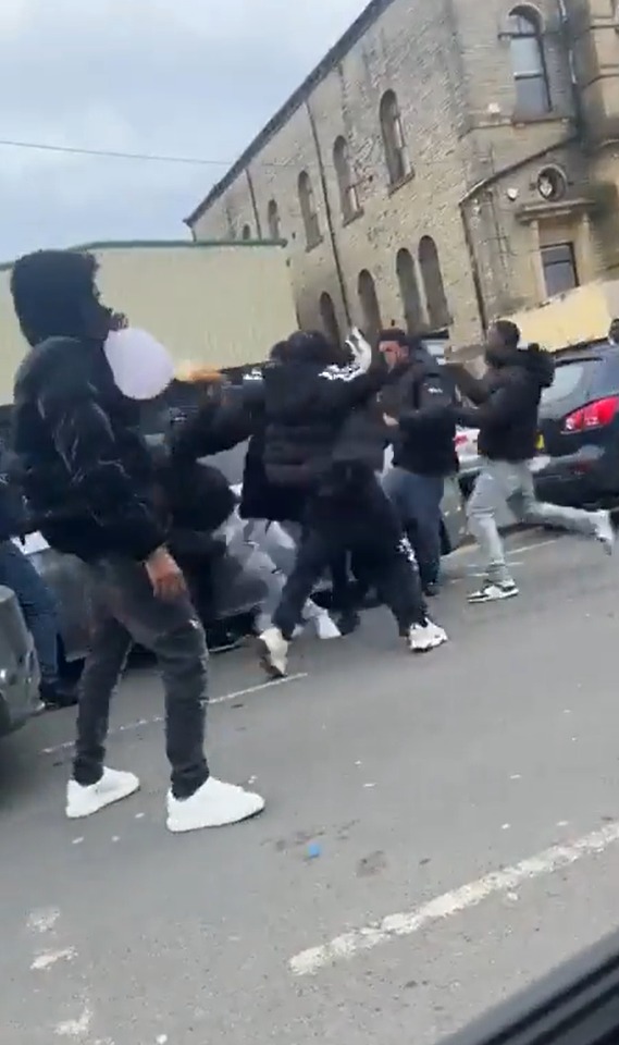 Groups of yobs were seen brawling in the middle of a road in broad daylight