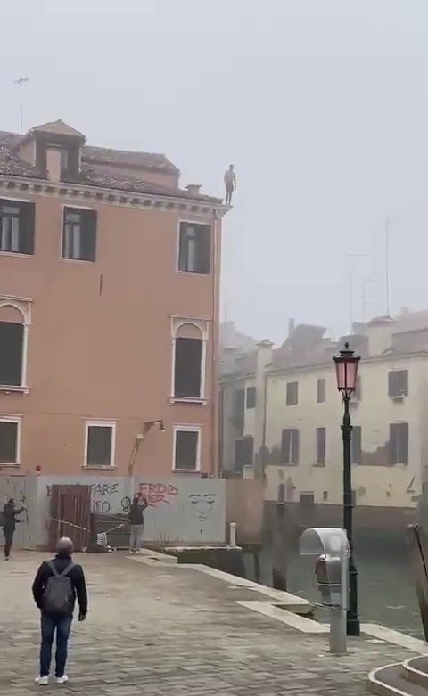 A tourist was filmed jumping from a 30ft building in Venice, Italy