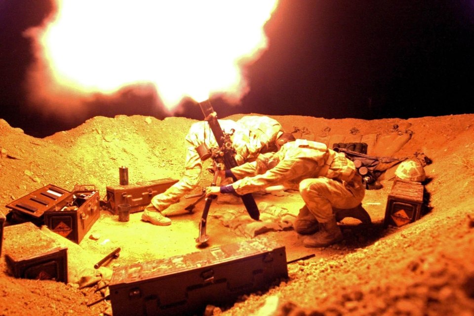 A Royal Marine with 40 Commando fires his weapon in Basra