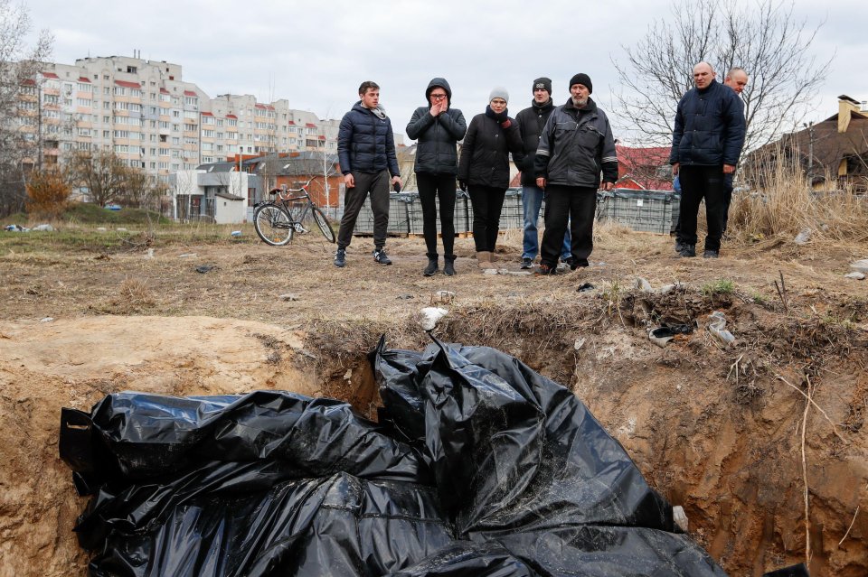 A mass grave where dozens of civilians are buried behind a church in Bucha