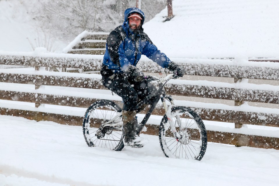 A man makes his way through the snow on January 18 in Carrbridge, Scotland