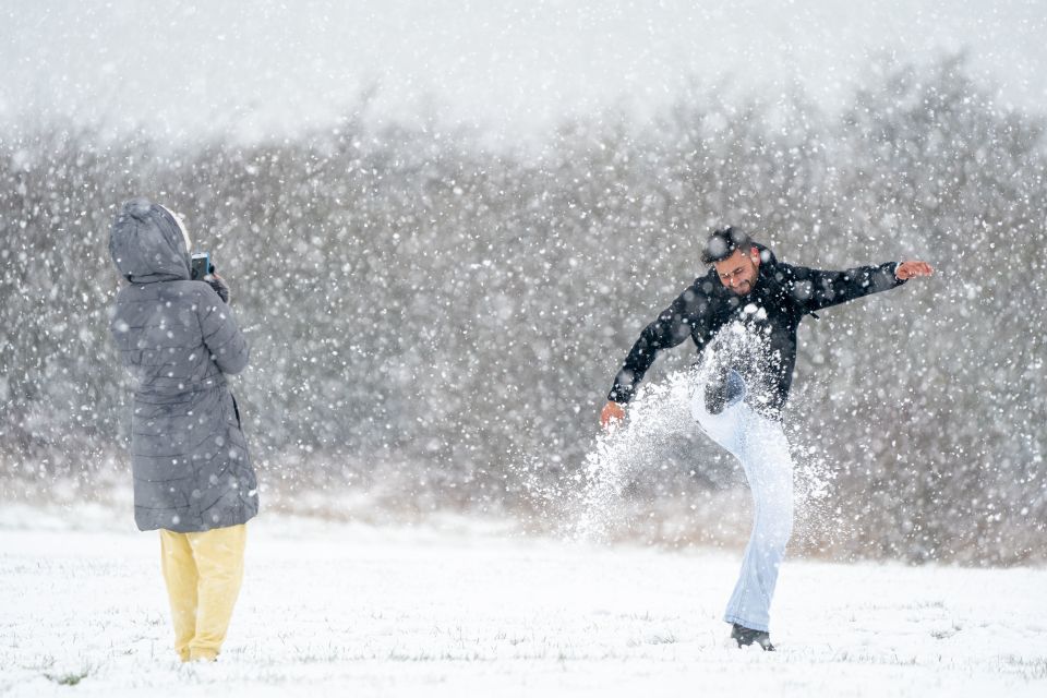 People play in the snow on the Dunstable Downs in Bedfordshire