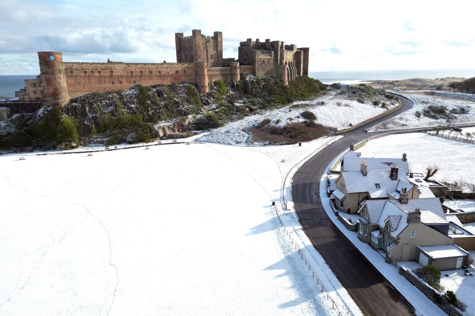 Bamburgh Castle surrounded by snow in Northumberland