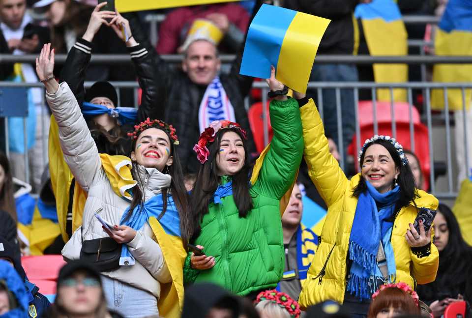 Ukraine supporters cheer and wave their flags