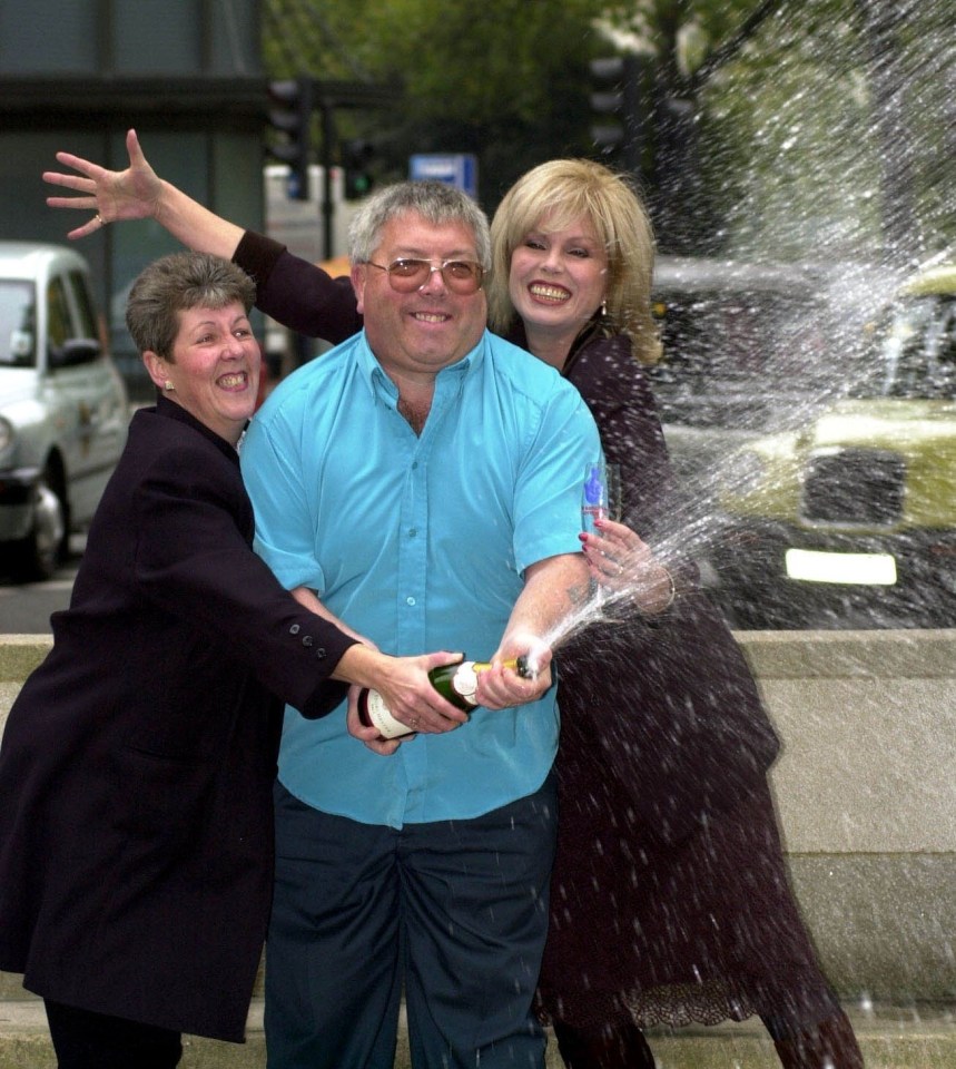 The couple celebrate their win after receieving the cheque from Joanna Lumley in 2001