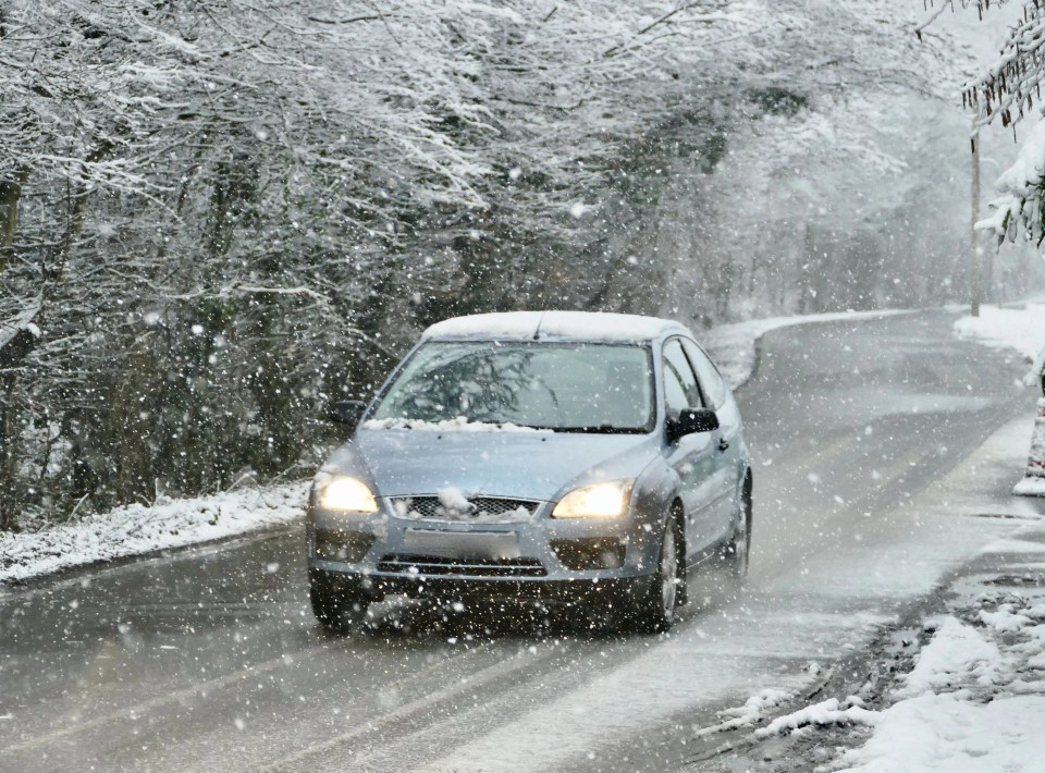 A driver battling snow and icy roads in Reading, Berkshire