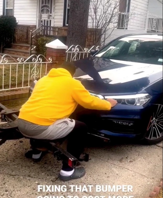 A shocking video of a driver trying to stop his luxury BMW from being towed away has emerged on social media