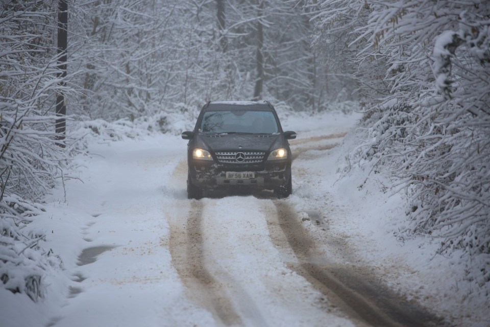 A car navigating a country lane in Broomfield, Somerset