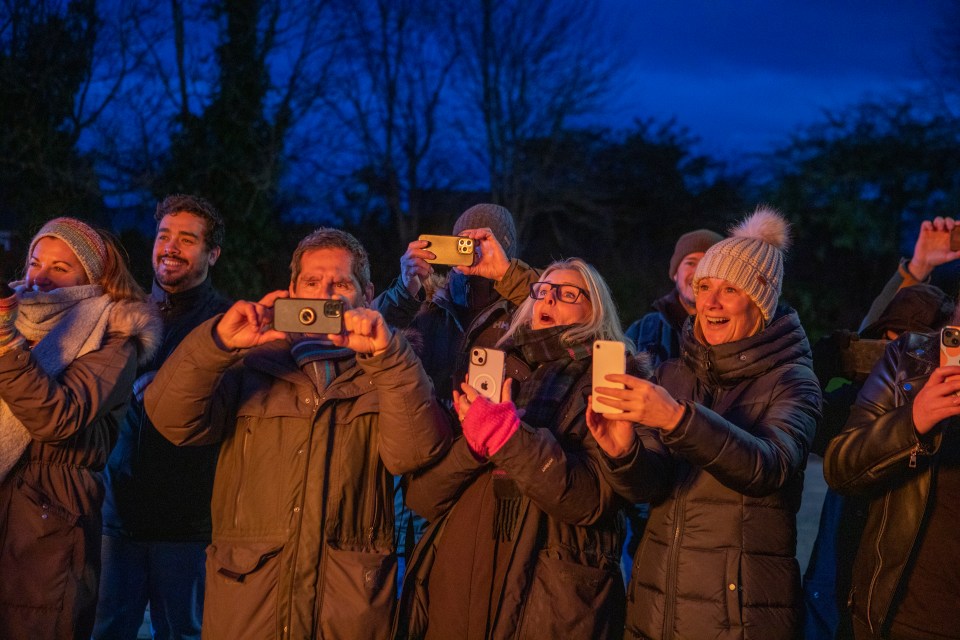 Locals look on as the ad goes up in flames