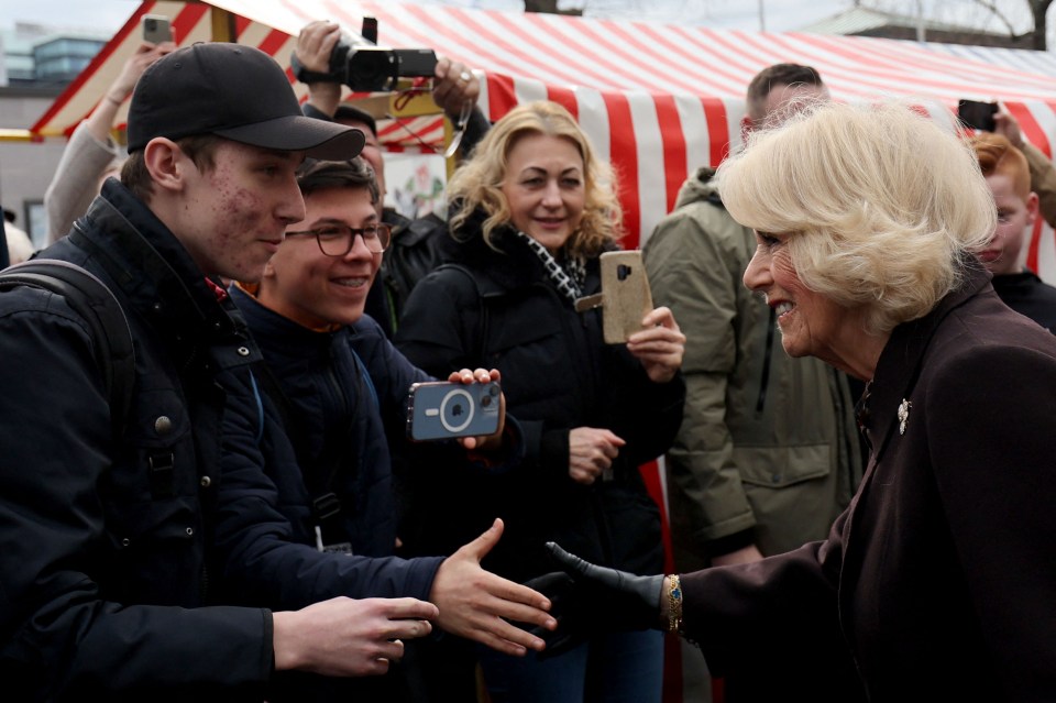 Camilla shook hands with well-wishers during the tour of the market