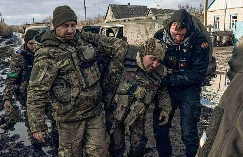 Injured Ivan is helped after suffering shrapnel wounds from the fighting