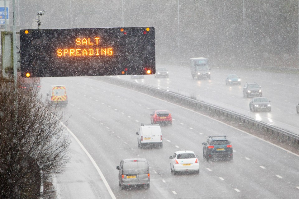 Cars drive through blizzard conditions on the M60 near Sale, Manchester