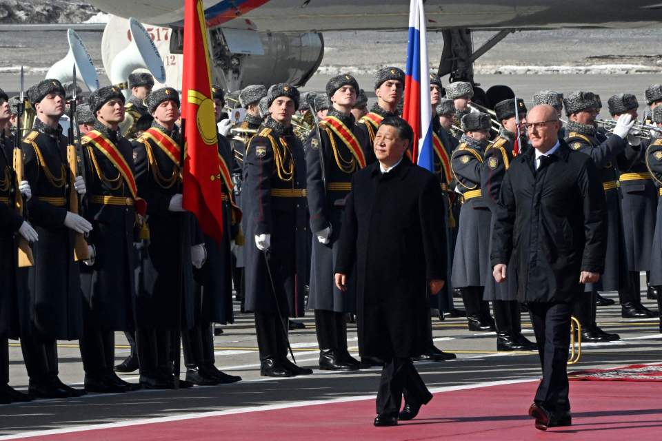 The Chinese leader inspecting a guard of honour on the tarmac