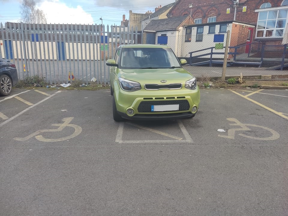 The owner of this lime green Kia sparked some furious debate online due to their 'inconsiderate' parking