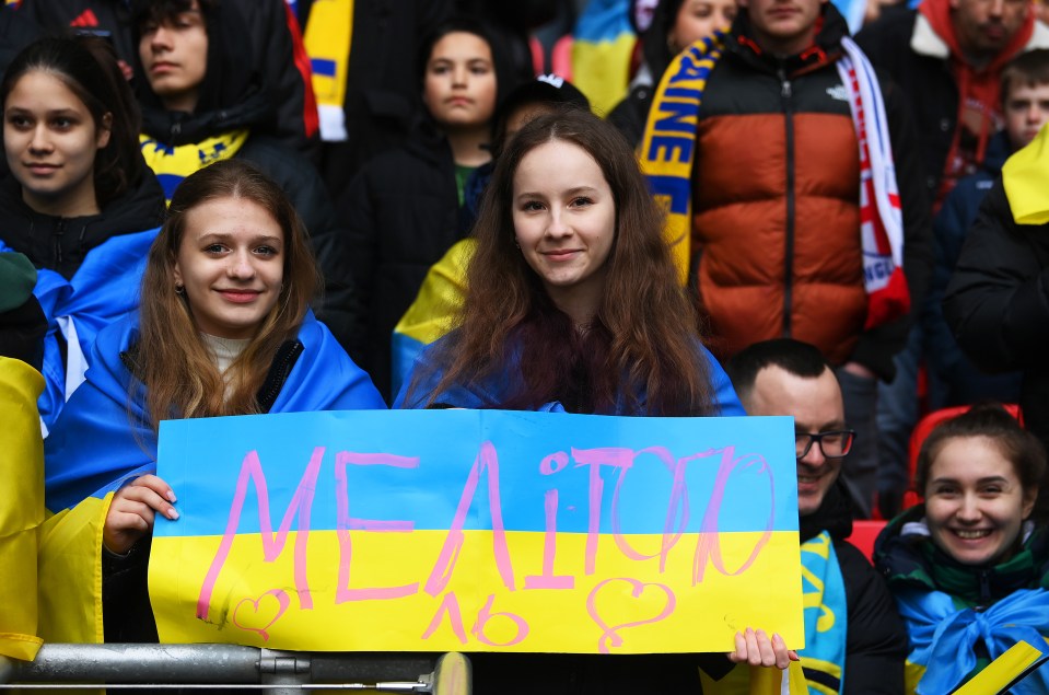 Ukrainian fans watched with banners showing their flag colours