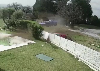 The moment the two Ferraris fly through the air and crash into a wall of a home