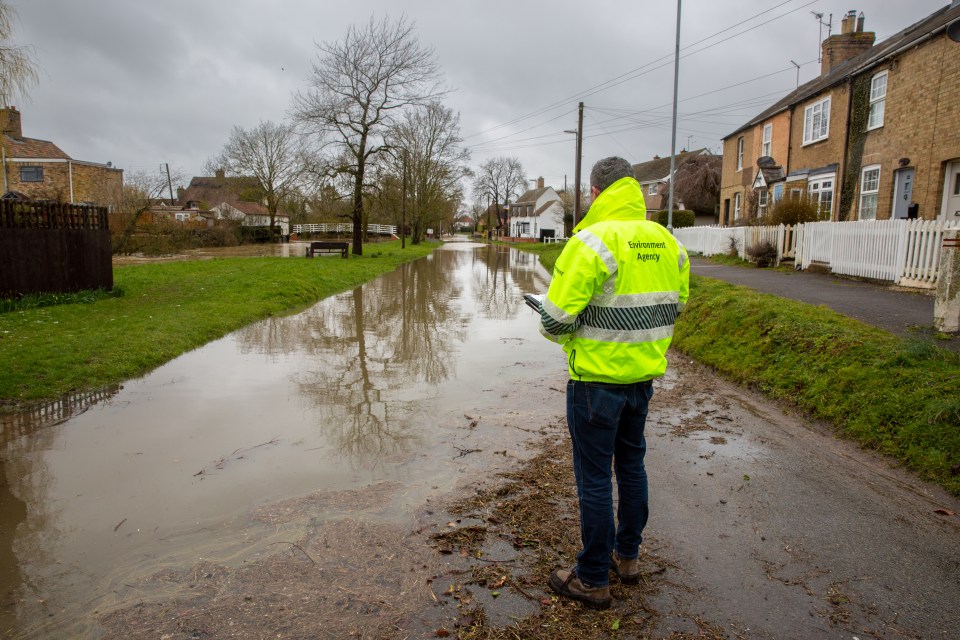 The Environment Agency checking the flooded high street through Alconbury in Huntingdonshire on Friday morning