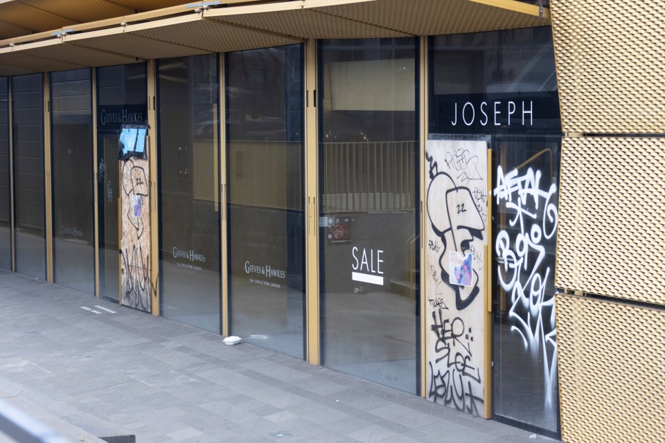 Hackney Walk now, with shop fronts boarded up and covered in graffiti