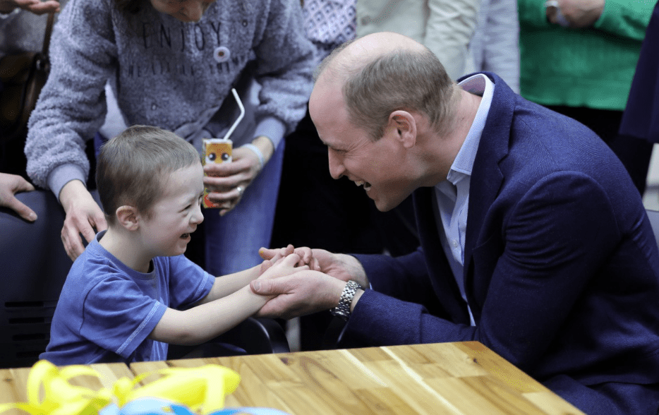 Prince William meeting a Ukrainian child at an accommodation centre in Warsaw