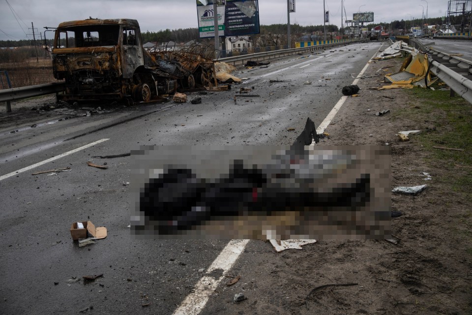 The lifeless body of a Russian soldier lies on the ground in Bucha