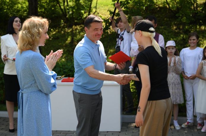 Ukrainian children receiving Russian citizenship from Moscow Governor Andrey Vorobyov seen with Maria Lvova Belova handing