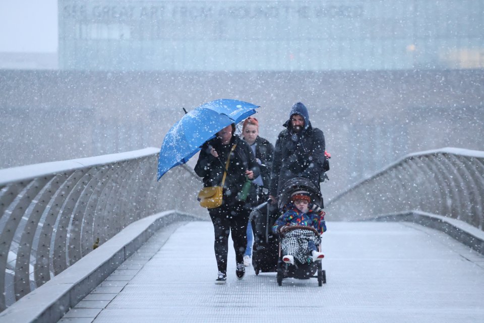 A family is battered by snow and chilly conditions in central London