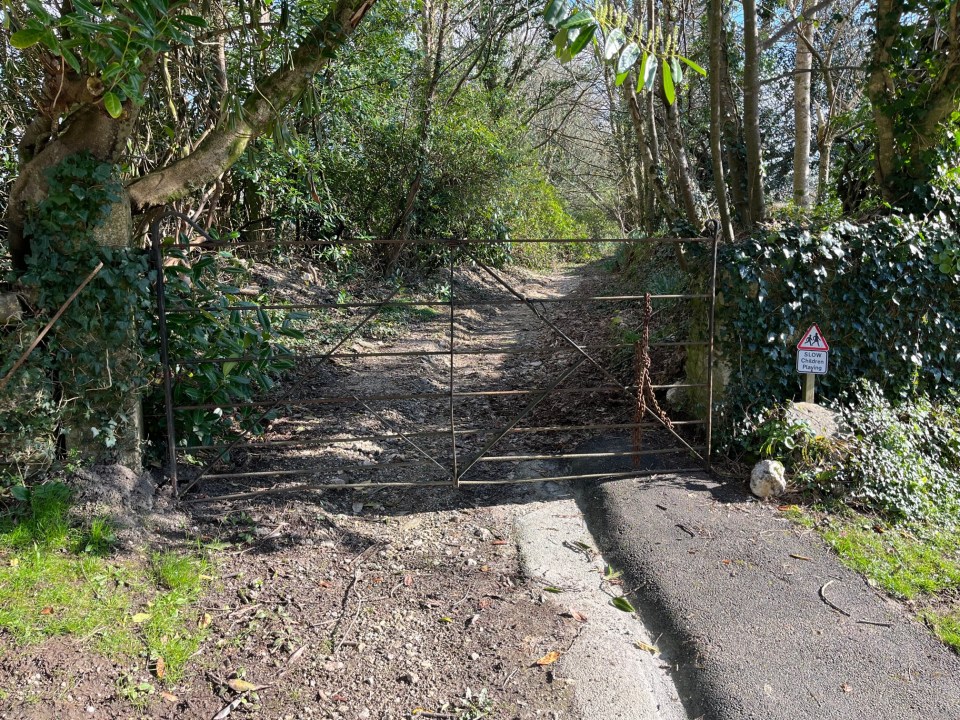 A gate blocks one end of the public footpath at Carnon Downs