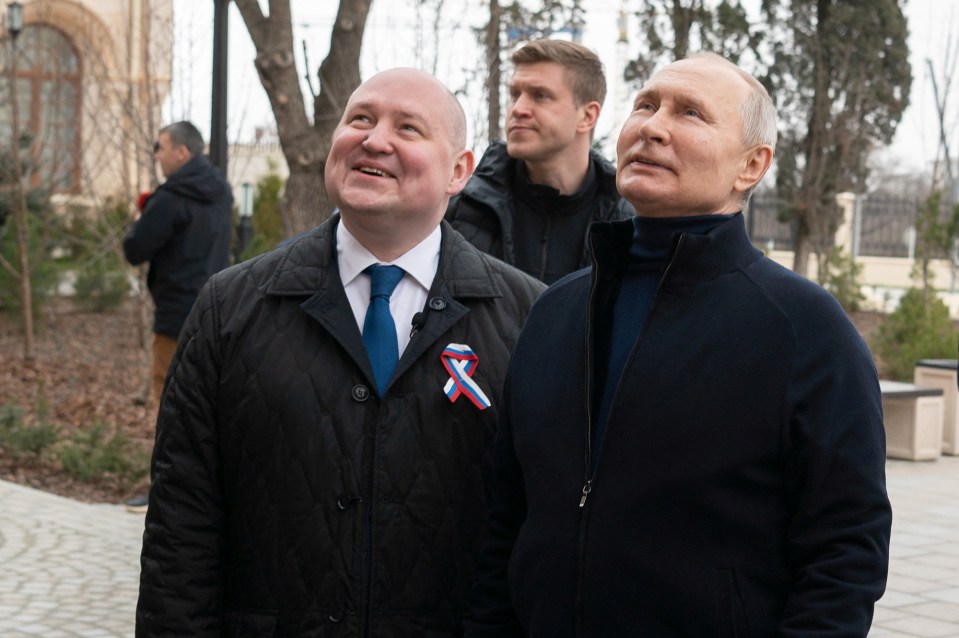 Putin attempts a smile while visiting a school in Sevastopol