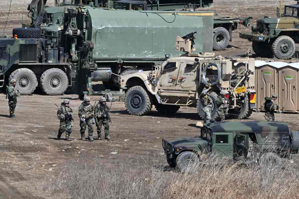 US soldiers walk past military vehicles at a training field in the city of Yeoncheon