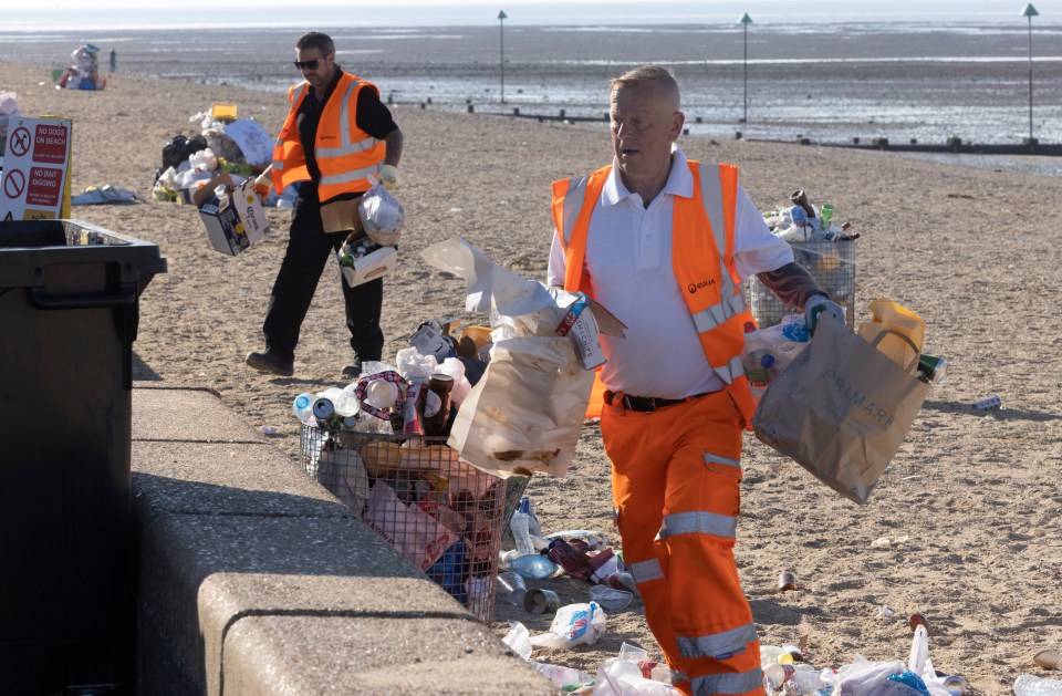 Workers clearing the beach of litter is not an unusual sight