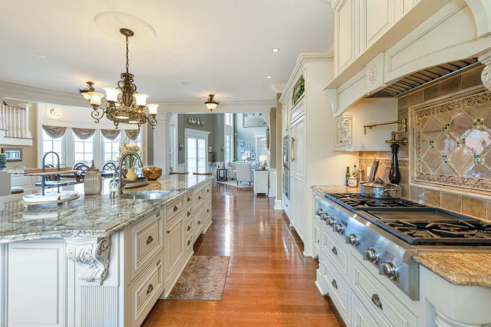 The kitchen features marble countertops and three dishwashers