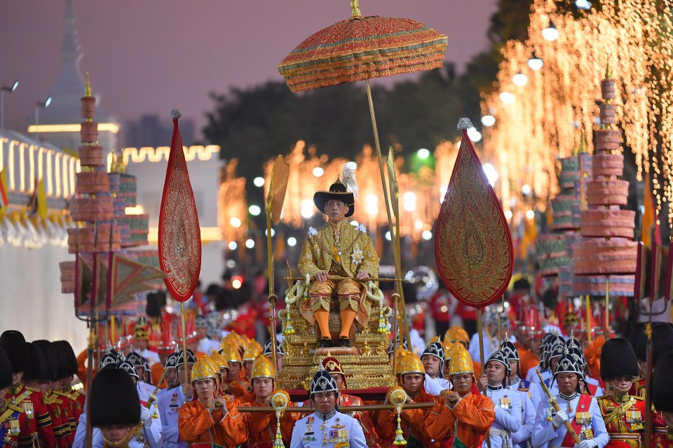 Thailand’s King Maha Vajiralongkorn is transported on the royal palanquin