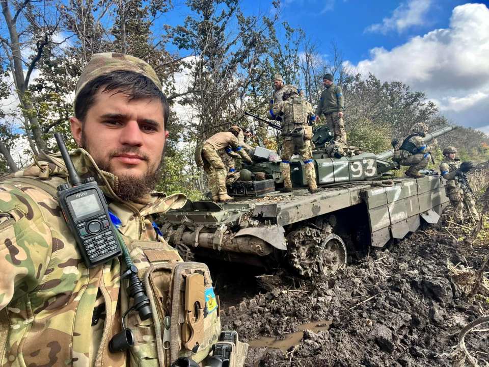 'Da Vinci' and his Wolves pose with a destroyed Russian tank