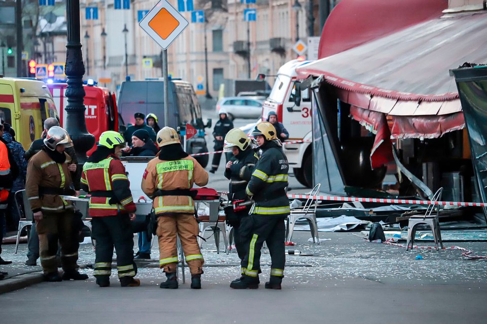 Scenes from the aftermath of the explosion with glass shattered over the street next to the collapsed façade of the café in central St. Petersburg