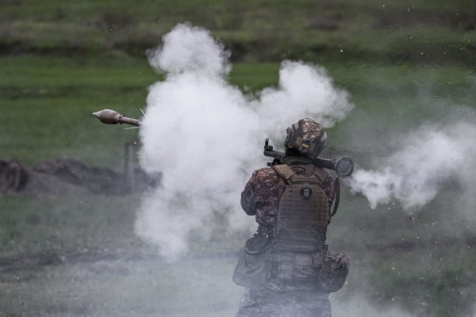 A Ukrainian soldier fires an RPG during training exercises