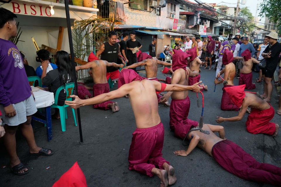 Penitents praying on their knees during the ritual